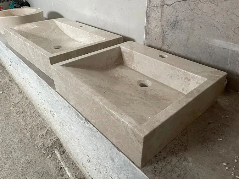 A wall-mount trough sink carved from a single travertine block